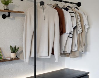 Wall-mounted clothes rack made of black steel tubing, industrial wall-mounted wardrobe, clothes stand with floor support for hallway and chest of drawers