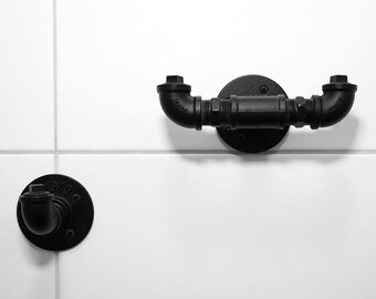 Black metal bathroom set, industrial-style towel rack and wall hooks as wall mounts for the bathroom