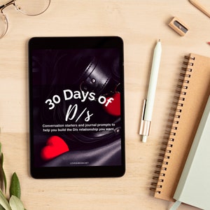 Cover of 30 Days of D/s workbook on tablet on desk next to pen and journals