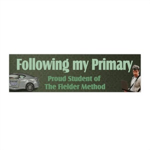 May include: A banner with the text "Following my Primary" in large, light green letters. Below, it reads "Proud Student of The Fielder Method." A silver car and a man with a laptop are on either side.