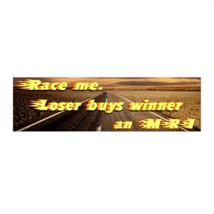 May include: A yellow and orange graphic with flames reads "Race me. Loser buys winner an MRE". The graphic is set against a background of a long, straight road disappearing into the distance.