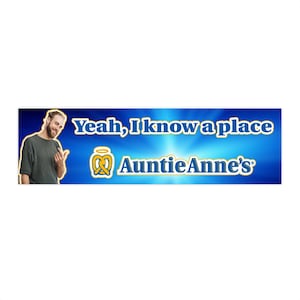 May include: A man points to a blue and white sign with the text "Yeah, I know a place" and a pretzel logo with the text "Auntie Anne's".