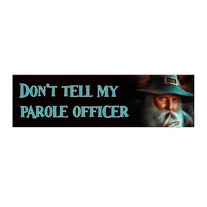 May include: A rectangular sign with the text "DON'T TELL MY PAROLE OFFICER" in teal letters. The right side features a portrait of a man with a long white beard, wearing a hat, and holding a finger to his lips.