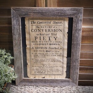 May include: A framed vintage print of a sermon titled "The Converted Sinner." The text discusses the nature of conversion to real and vital piety and the manner in which it is to be prayed and striven for. The sermon was preached in Boston on May 31, 1724, at the desire of certain pirates, a little before their execution.