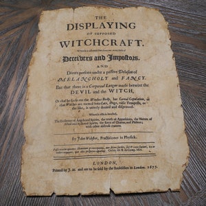 May include: A vintage, yellowed page from a book titled "The Displaying of Supposed Witchcraft." The text discusses the nature of witchcraft and the supposed league between the devil and witches. The book was printed in London in 1677.