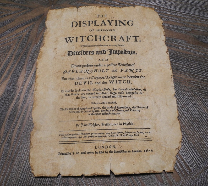May include: A vintage, yellowed page from a book titled "The Displaying of Supposed Witchcraft." The text discusses the nature of witchcraft and the supposed league between the devil and witches. The book was printed in London in 1677.