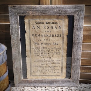 May include: A framed antique print with the title "An Essay Upon Remarkables in the Way of Wicked Men." The print is a sermon on the tragic end of 26 pirates in 1723. The print is in black and white and has a distressed look.