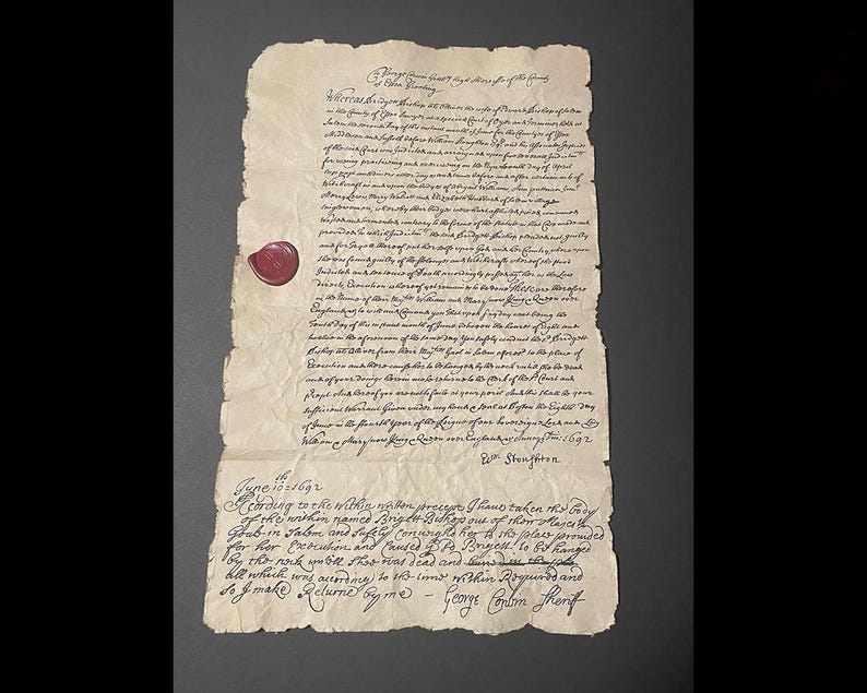 Op de afbeelding: Een oud perkamentdocument met handgeschreven tekst en een rode waszegel. Het papier is verouderd, met kreukels en scheuren. De tekst is in een formeel schrift, met de datum 1692 zichtbaar. Het document lijkt een historisch document te zijn.