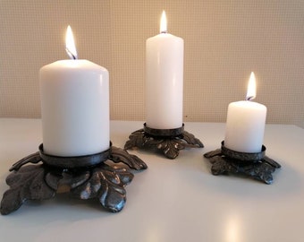 Iron candle holders for pillar candle. Set of three flower shaped candleholders.
