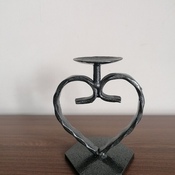 Heart shaped iron candle holder with hexagonal base.