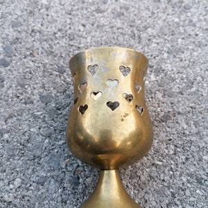 Vintage hearts pierced brass plated tealight candle holder.