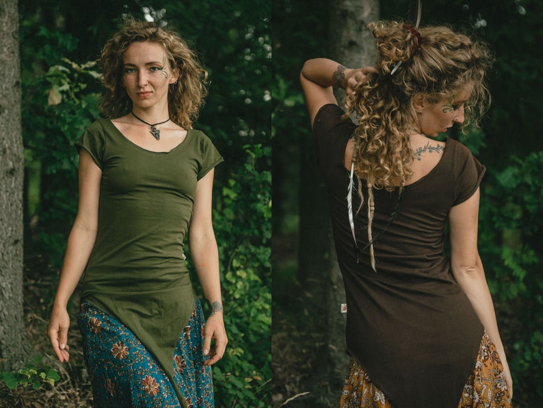 May include: A fitted olive green short-sleeved top with a scoop neckline and an asymmetrical pointed hemline. The garment features a solid color design with a small side tag, shown from both the front and back views to display the cut and fit.