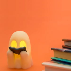 Ghost Holding Book Figurine: Spooky Halloween Desk Decor with Tea Light