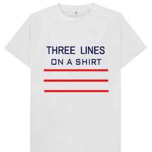 May include: White t-shirt with the text "THREE LINES ON A SHIRT" in navy blue and three red horizontal lines.