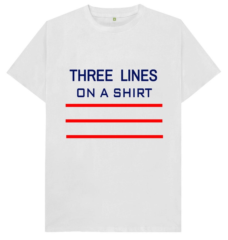 May include: White t-shirt with the text "THREE LINES ON A SHIRT" in navy blue and three red horizontal lines.