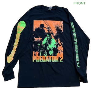 May include: Black long-sleeve shirt featuring a graphic from the movie "Predator 2". The front graphic is orange and green, with the movie title. The left sleeve has a green design, and the right sleeve has text.