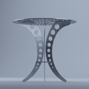 May include: A modern, silver-colored metal side table. The table has a round top with several small holes and curved legs with circular cutouts. The table's height is approximately 30 inches.