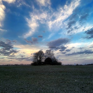 Photo print Sunset sky over an abandoned farmhouse.