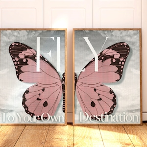 May include: Two framed prints with a pink butterfly on a white background. The text "FLY" is in large white letters. The text "To Your Own Destination" is below the butterfly on the left print. The text "Destination" is below the butterfly on the right print.