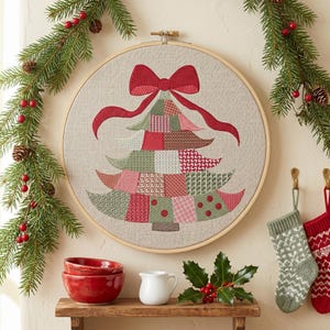 🎄 A whole quilt's worth of charm in one tree — no fabric, no applique, every patch stitched right on your machine. This patchwork Christmas tree layers green, red and blush patches in mixed prints, topped with a generous red bow and trailing ribbon tails. Part of the Patchwork Series in the shop, the festive companion to the Patchwork Santa designs.