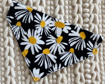 May include: Black and white bandana with a daisy print. The daisies have yellow centers.