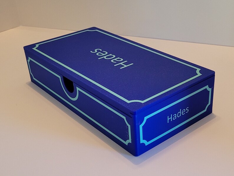 May include: A blue box with a light blue border and the word "Hades" written on the top and bottom of the box.