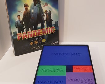 May include: A blue box with the word "Pandemic" printed on the top. The box contains four smaller boxes, each with a different color and a different Pandemic expansion title: "State of Emergency", "On the Brink", "Expansion Cards", and "In the Lab".