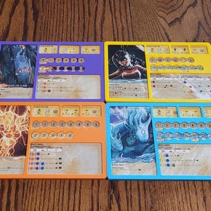 May include: Four colorful game boards with illustrations and text. The boards are purple, yellow, orange, and blue. Each board has a different image and a series of icons and text boxes. The boards appear to be for a tabletop game.
