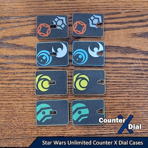 May include: Eight black and white counter dials with different symbols. The dials are made of plastic and have a textured surface. The text "Counter X Dial" is visible in the bottom right corner of the image.  Star Wars Unlimited Counter X Dial Cases.