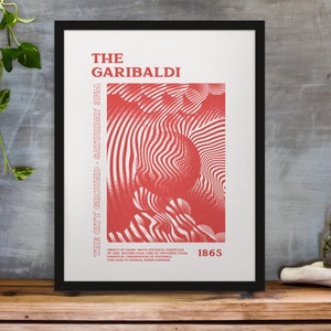 Könnte beinhalten: Gerahmter Kunstdruck mit dem Text "THE GARIBALDI" in Rot, mit abstrakten roten und weißen Wellenmustern. Der Text "THE CITY GROUND - SATURDAY 3PM" ist ebenfalls sichtbar. Der Druck wird auf einer Holzoberfläche angezeigt.