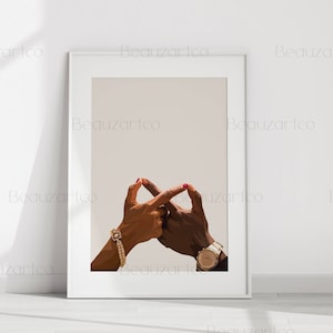 May include: Two hands intertwined, forming a heart shape. The hands are adorned with jewelry, including a pearl bracelet and a gold watch.