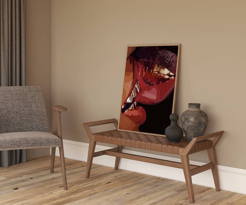 May include: A framed art print featuring a close-up of lips with gold teeth. The artwork uses shades of red, brown, and black. The print is displayed on a wooden bench with a woven leather seat, next to decorative vases.
