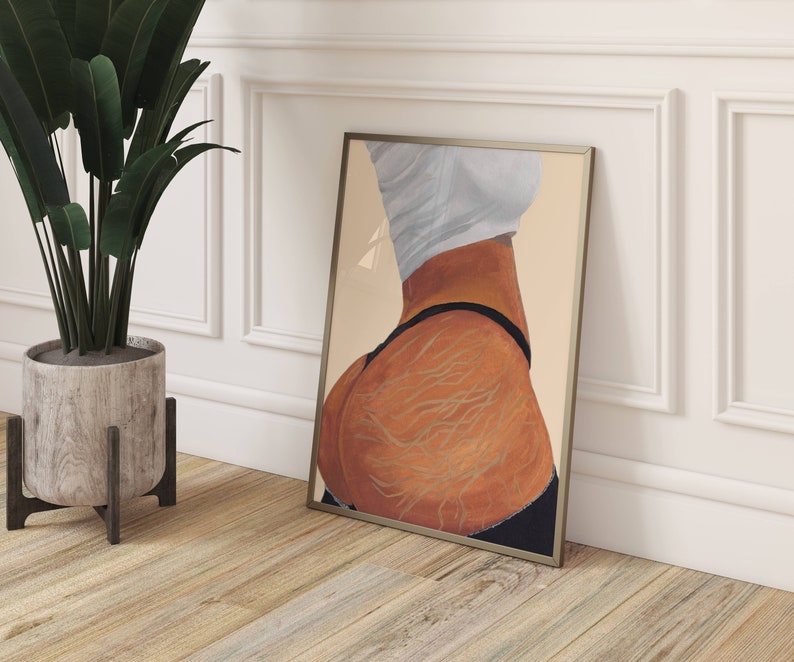 May include: A framed print of a painting depicting a person's lower body with detailed lines and a black thong. The background is a light beige color.