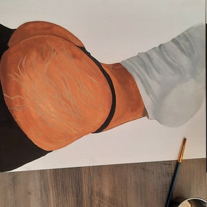 May include: A close-up of a painting on paper of a person's torso. The painting is done in shades of brown, black, and white. The person is wearing a white shirt and black underwear. A paint palette with brown paint is visible in the foreground.