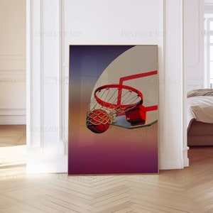 May include: A basketball going through a hoop with a red rim and a white backboard. The background is a gradient of purple, pink, and orange.