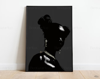 May include: Black and white art print of a woman in profile, framed in black. The image features a silhouette with detailed jewelry and a high bun hairstyle. The artwork is displayed on a white wall and wooden floor.