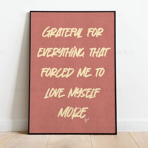 May include: A framed print with a red background and white text that reads "Grateful for everything that forced me to love myself more".