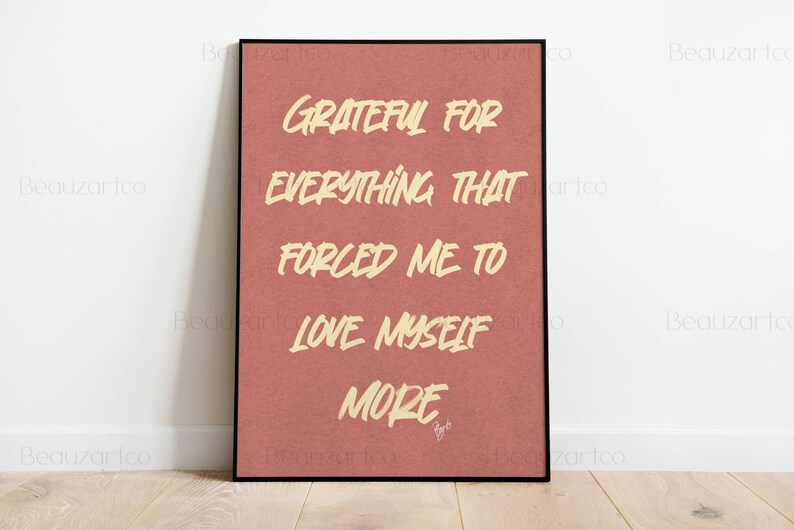 May include: A framed print with a red background and white text that reads "Grateful for everything that forced me to love myself more".