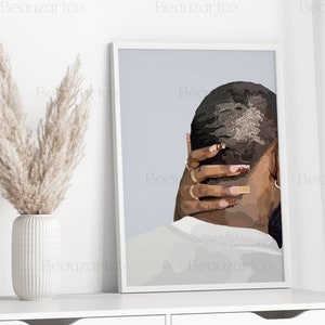 May include: A framed illustration of a person's back with a short haircut. The person is wearing a white shirt and has their hand on the back of their neck. The background is a light blue color.
