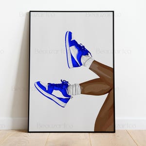 May include: A framed art print featuring a stylized illustration of legs wearing blue and white sneakers and white socks. The artwork is set against a white background, with the legs and sneakers in a dynamic pose.