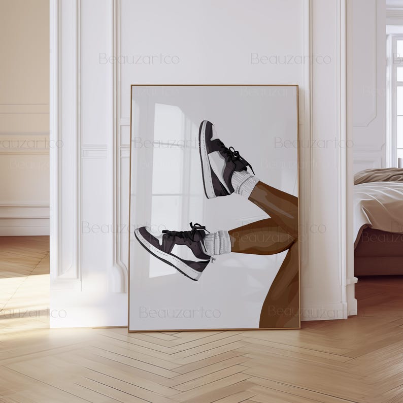 May include: A framed art print featuring a stylized illustration of legs wearing black and white sneakers and white socks. The artwork is set against a white background, with the legs and shoes in a dynamic pose. The frame is gold.