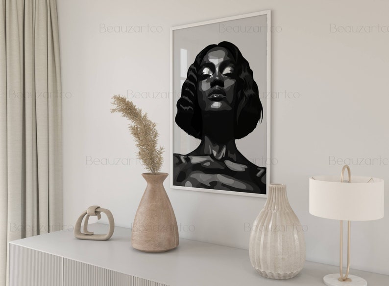 May include: Black and white illustration of a woman's face with her eyes closed. The illustration is framed and hanging on a white wall.