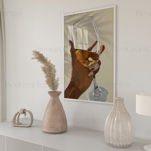 May include: A hand holding a glass of white wine, with sunlight streaming through the window behind it. The glass is clear and the wine is a pale yellow color.