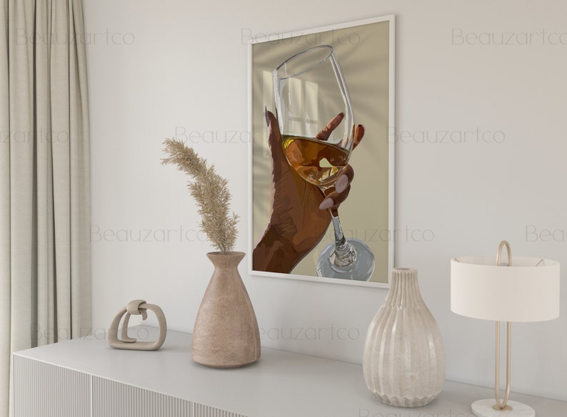 May include: A hand holding a glass of white wine, with sunlight streaming through the window behind it. The glass is clear and the wine is a pale yellow color.