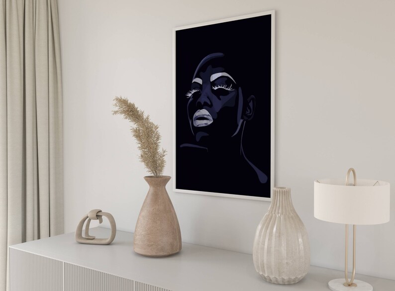 May include: A black and white illustration of a woman's face with dramatic makeup. The woman is looking up and her eyes are closed. The background is black.