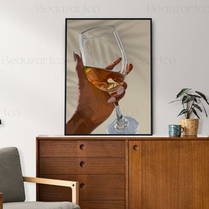 May include: A hand holding a glass of amber-colored liquid. The glass is clear and has a long stem. The hand is brown and has long, manicured nails. The background is a light beige color.
