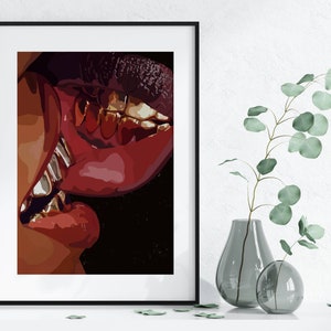 May include: A framed art print featuring a close-up of two sets of lips in a kiss. The lips are a deep red with gold teeth. The artwork is set against a black background.