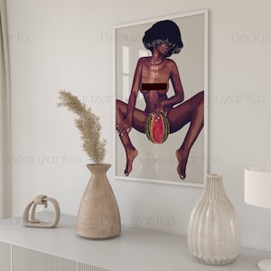 May include: A framed illustration of a woman with dark skin and short, curly hair. She is sitting with her legs spread and holding a watermelon in her lap. The background is a light gray color.