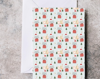 May include: A Christmas card with a repeating pattern of gray cats wearing Santa hats and red sweaters. The cats are holding books and are surrounded by green Christmas trees and snowflakes. The card is inside a white envelope.
