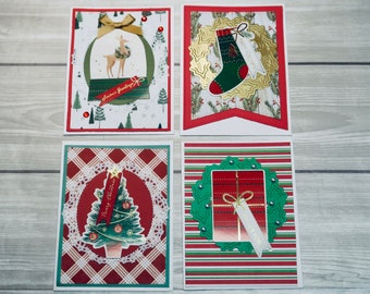 May include: Four Christmas cards with different designs. The first card features a snow globe with a deer inside and the text "Season's Greetings". The second card has a green stocking with a gold wreath and the text "Merry Christmas". The third card has a green Christmas tree with a red and white plaid background and the text "Merry Christmas". The fourth card has a red and white striped background with a green wreath and a gift box inside and the text "Thank You".